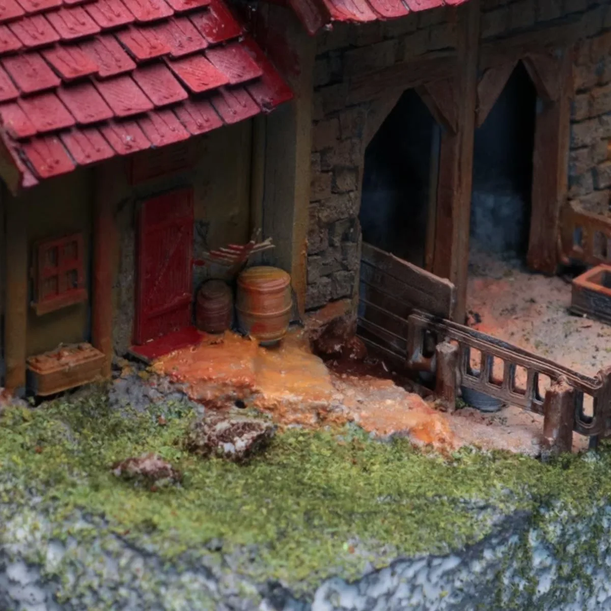 Painted printed barrels, crate, door and fence beside the cottage
