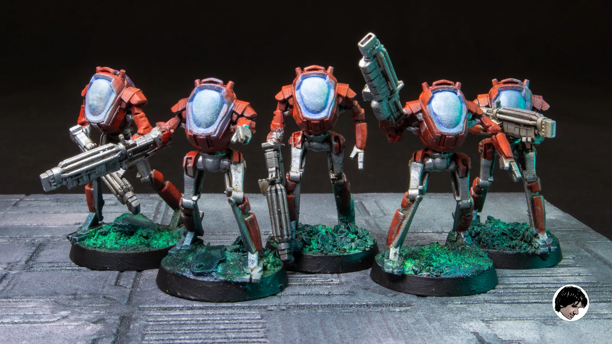 Five of the original robot Drone poses, printed and painted red and silver